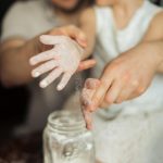 pexels-photo-3807314-3807314 Happy crop cute girl with pigtail and blurred father shaking off flour from hands while making dough